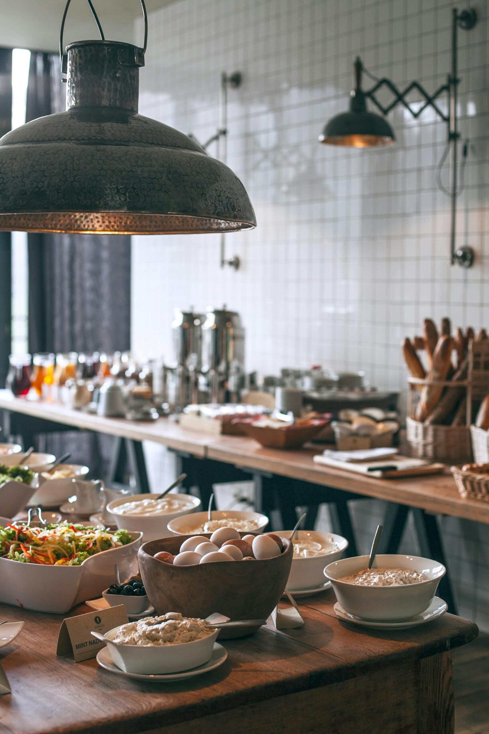 Inviting breakfast buffet featuring eggs, salads, and fresh ingredients in a stylish setting.